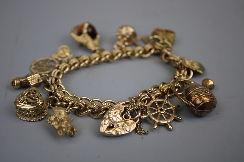 9ct Gold Bracelet &amp; Charms Approx. Gross Weight 61.3g (10% buyer’s premium on this Lot)