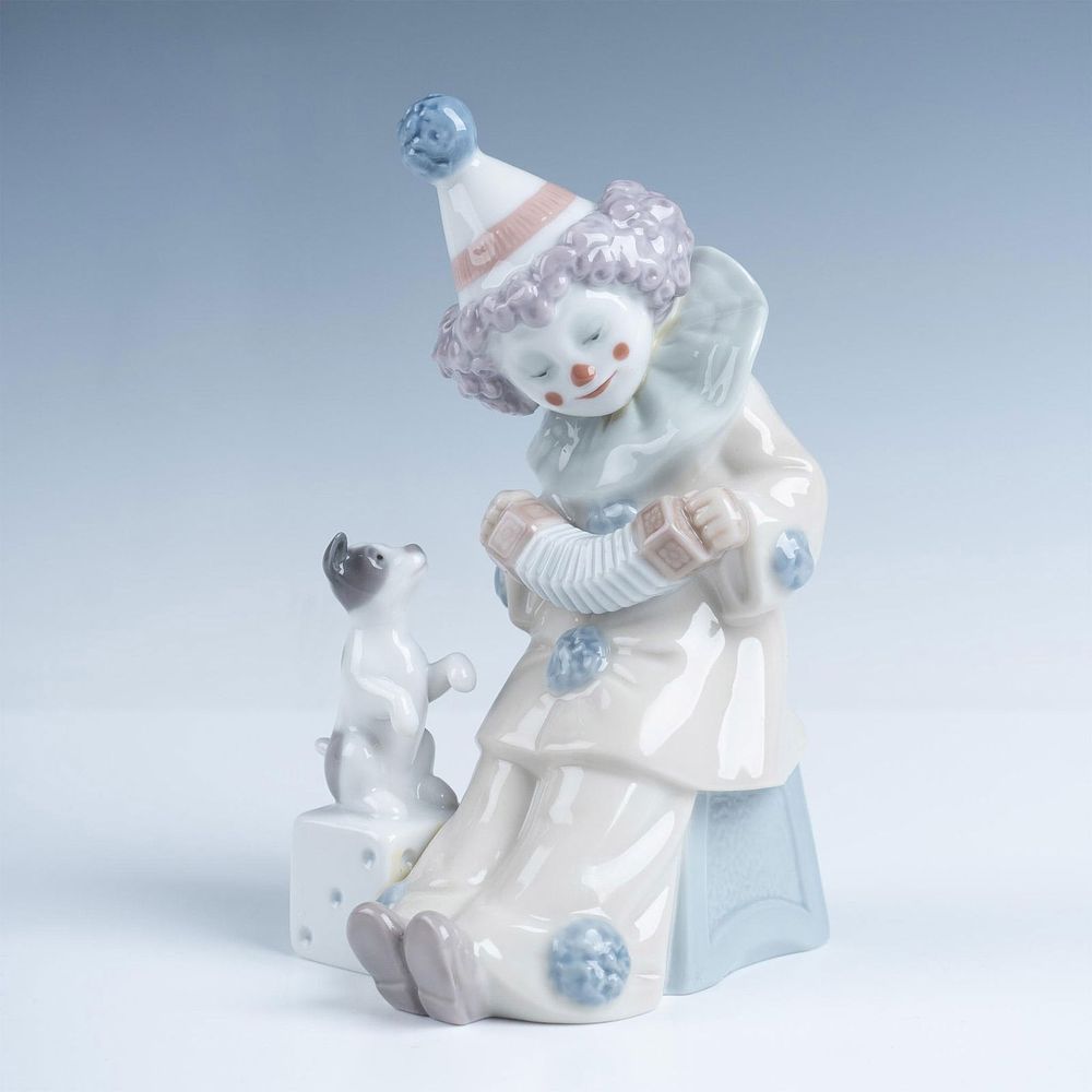 Pierrot with Concertina 1005279 - Lladro Porcelain Figurine. Adorable Pierrot depicted playing 