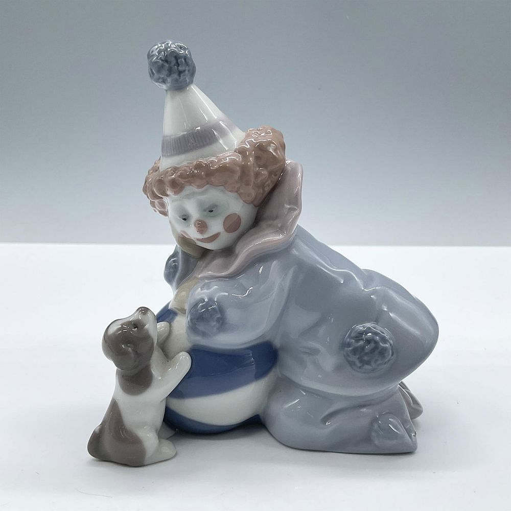 Pierrot w/ Puppy & Ball 1005278 - Lladro Porcelain Figurine. Glossy porcelain figure of a boy 