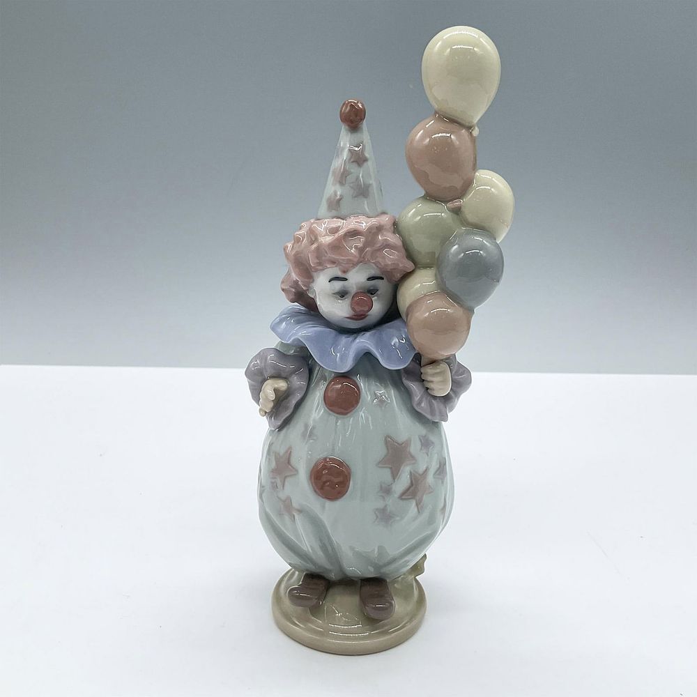 Littlest Clown 1005811 - Lladro Porcelain Figurine. An adorable clown dressed in a blue suit 