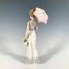 Garden Classic 1007617 - Lladro Porcelain Figurine. Glossy figure of a woman holding a pink Image - 1