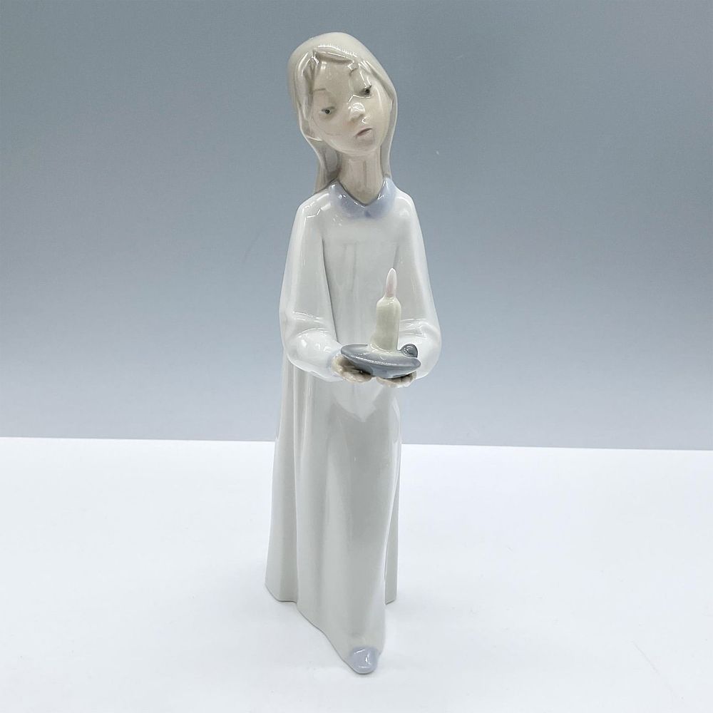 Girl with Candle 1004868 - Lladro Porcelain Figurine. Glazed figural with candle. Colored in 