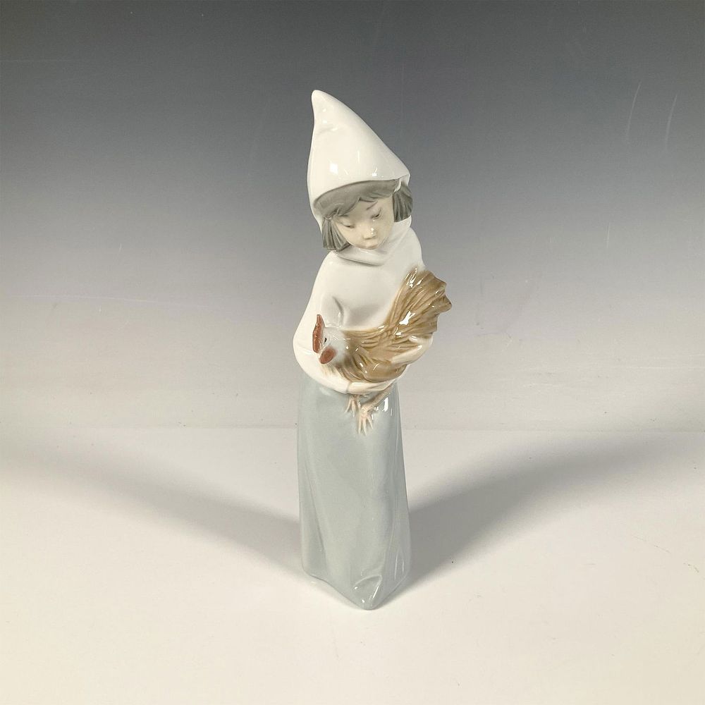 Girl with Rooster 1004677 - Lladro Porcelain Figurine. A glossy figure of a young girl cradling 