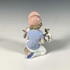 Little Riders 1007623 - Lladro Porcelain Figurine. A glossy figure depicting a young boy holding Image - 1