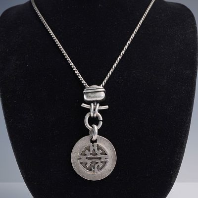 Long Chain Necklace with Cutout Medallion Pendant and Toggle Detail. This striking necklace