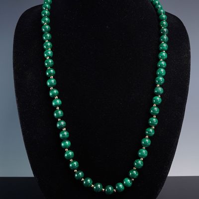 Polished Malachite Bead Necklace with Gold-Tone Spacers. This elegant strand features highly