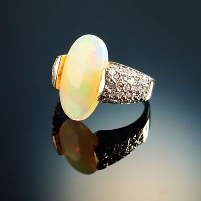 14K Gold Ring with 4.34ct Opal and 1.00ct Diamond Accents. A dramatic 14K yellow gold ring