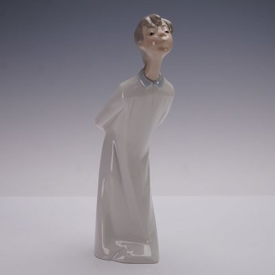 Nao by Lladro Porcelain Figurine, Boy in Long Robe. A Nao by Lladro porcelain figurine depicting 