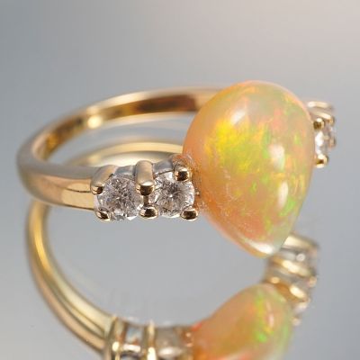 14K Gold Ring with 2.77ct Pear-Shaped Opal and Diamond Accents. Featuring a mesmerizing 2.77 