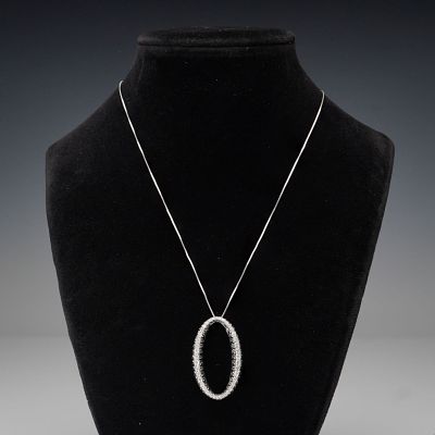 14K White Gold 2.50ctw Black and White Diamond Oval Pendant Necklace. A striking 14K white gold 