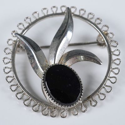 Sterling Silver Floral Brooch with Black Onyx. This petite sterling silver brooch features an 