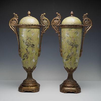 Pair of Ornate Porcelain and Gilt Metal Covered Decorative Urns. An elegant pair of covered urns 