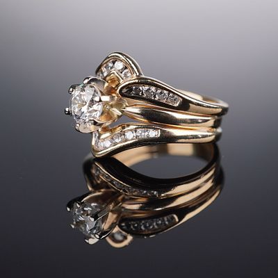 14K Gold .78ctw Contour Diamond Ring. Centered with a round brilliant-cut diamond weighing 