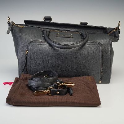 Kate Spade Baxter Street Asphalt Shoulder Bag. Features a structured pebbled leather body with 