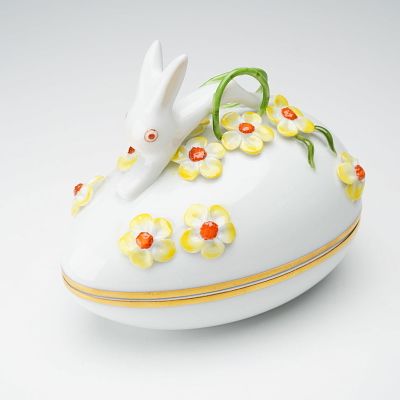 Herend Porcelain Bunny Rabbit Egg Shape Treasure Box. A playful bunny perches atop a field of 