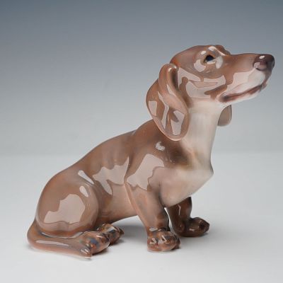 Dahl Jensen Porcelain Figurine, Dachshund. Figurine of a seated dachshund modeled in soft brown 