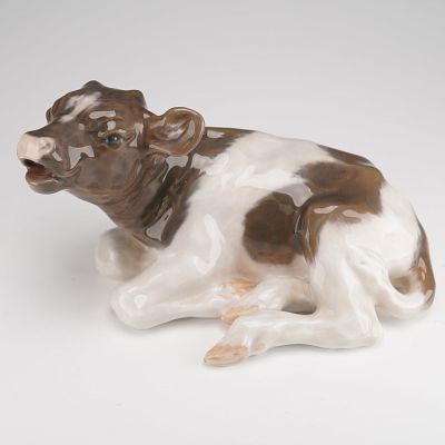 Royal Copenhagen Porcelain Figurine, Calf 1072. Modeled as a resting calf with its head angled 