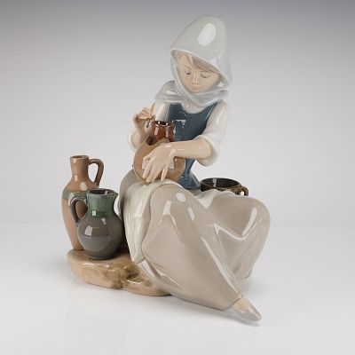 Lladro Porcelain Figurine Woman Painting Vase Model #5079. A single glazed porcelain figurine by 