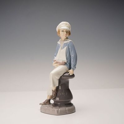 LLADRO Boy With Yacht Porcelain Figurine, Model 4810. Porcelain figurine titled Boy With Yacht 