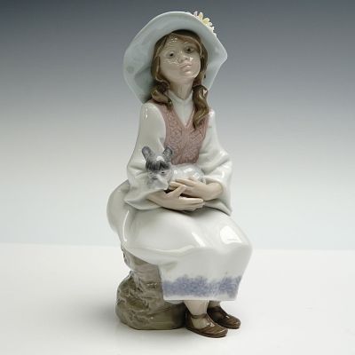 Lladro Porcelain Figurine, Daydreams 1006400. Glazed finish figure modelled as a young girl 