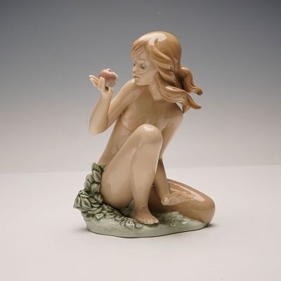 Lladro Porcelain Figurine, Eve 1001482. This glazed porcelain figurine depicts a seated female 