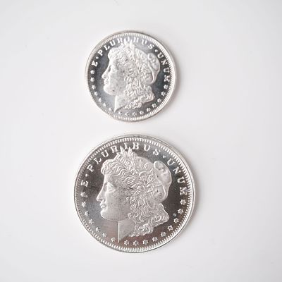 2pc Highland Mint Morgan Silver 1/2 and 1/4 Troy Ounce Coins. A two-piece coin collection 