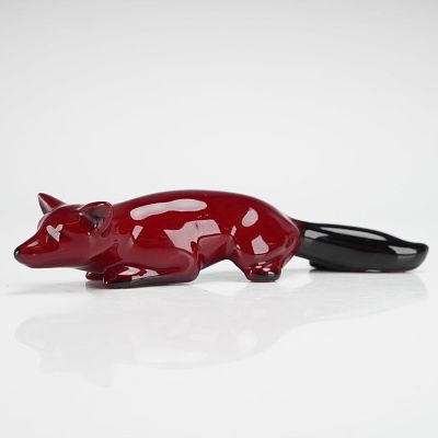 Royal Doulton Flambe Fox Stalking Figurine HN147E. The piece depicts a stylized reclining fox in 