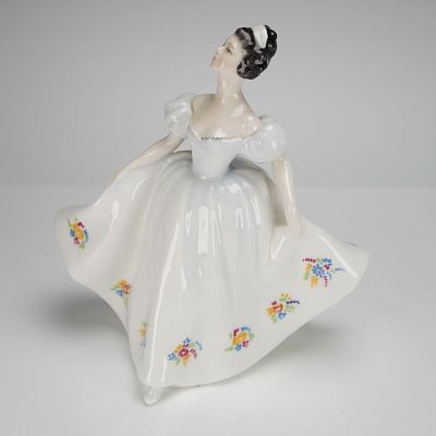 Royal Doulton Figurine Kate HN 2789. The piece depicts a young woman in a dynamic, full-skirted 