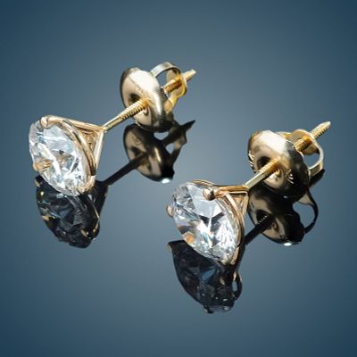 Pair of 14K Gold and 1.50ctw Diamond Stud Earrings. A pair of 14K yellow gold earrings featuring 