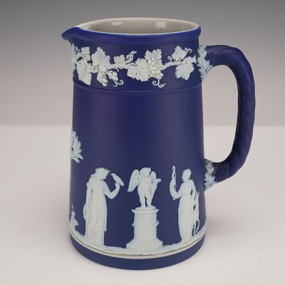 A Wedgwood Neo-Classical Dark Blue Jasperware Jug, featuring a matte deep blue exterior with 