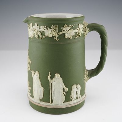 A Wedgwood Sage Green Jasperware Pitcher of Neoclassical style, featuring white bas-relief 
