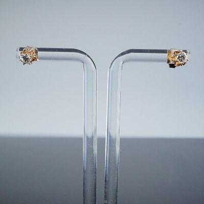 14K Yellow Gold Solitaire Diamond Stud Earrings. A pair of 14K yellow gold solitaire stud 