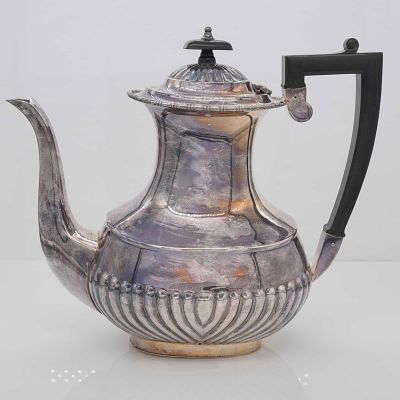 William Adams and Sons Silver-Plated Coffee Pot. The vessel is designed in a Georgian Revival 
