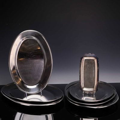 Set of 7 Stainless Steel Platters and a Scalloped Serving Dish. The group includes 7 platters of 