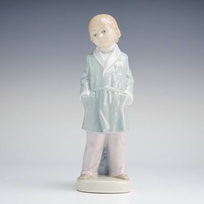 Lladro Porcelain Figurine Boy with Robe 4900. A Lladro Porcelain Figurine, Boy with Robe 