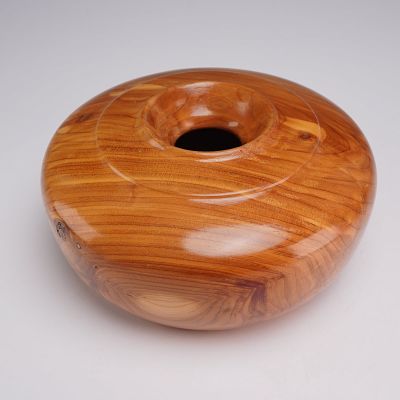 Hand-Turned Cedar Wood Bowl. This hand-turned cedar wood vessel features a squat, bulbous form 
