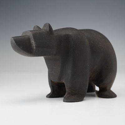 Carved Black Basalt Bear Statuette. A carved black basalt bear figurine rendered with a compact 