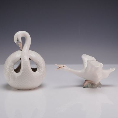 Two Lladro Porcelain Bird Figurines Including a Flying Duck. This lot features two glazed white 