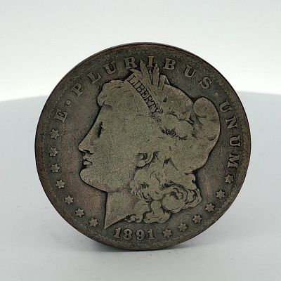 1891 US Morgan Silver Dollar Coin Circulated. This US silver coin is a Morgan dollar struck at 