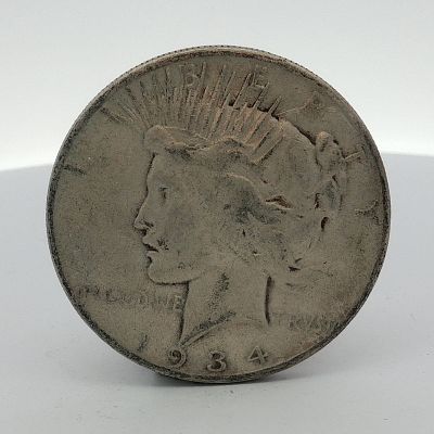 1934-S US One Dollar Peace Silver Dollar Coin, Circulated. This United States silver one dollar 