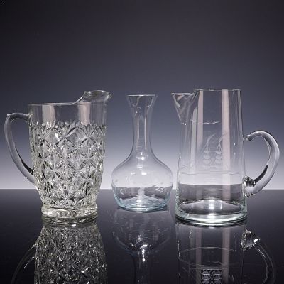Princess House Glass Items Including a Nautical Theme Pitcher, a Cut Pattern Pitcher, and a Carafe. 