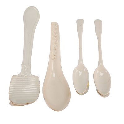 A 4pc Wedgwood Embossed Queen's Ware Butter Curler, Soup Spoon, and Two Teaspoons. A four-piece 