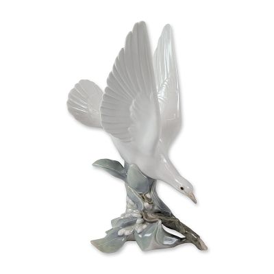 Lladro Porcelain Turtle Dove Figurine. (Model #4550), depicting a white bird in flight landing 