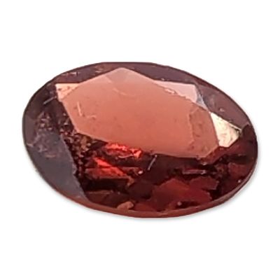 Loose Oval Faceted Reddish-Brown Gemstone. A loose faceted gemstone, oval cut, featuring a 