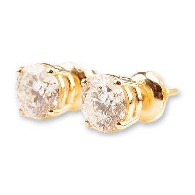 14K Gold 1.55ctw Diamond Stud Earrings. A pair of yellow gold screw-back stud earrings featuring 