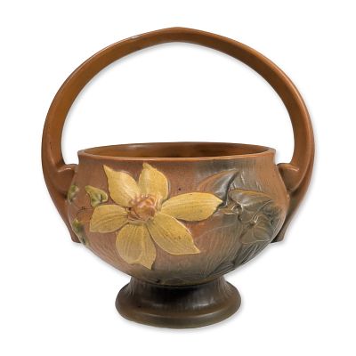 Roseville Pottery Pedestal Basket, Clematis. The vessel features a rounded body with a high 
