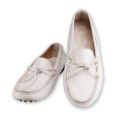 Tod's Gommino Driving White Loafers. A pair of Tod's Gommino driving loafers featuring a white 