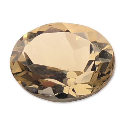 Faceted Oval Citrine Gemstone. One loose faceted citrine gemstone. The stone features a pale 