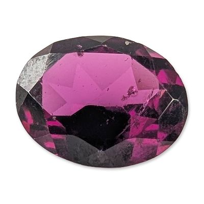 Oval Mixed Cut Rhodolite Garnet. A loose faceted gemstone fashioned in an oval mixed cut 