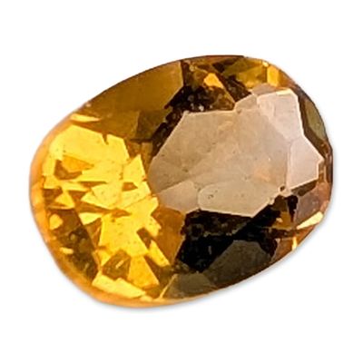 Oval Mixed Cut Orange Sapphire Gemstone. A loose faceted gemstone that appears to be sapphire 